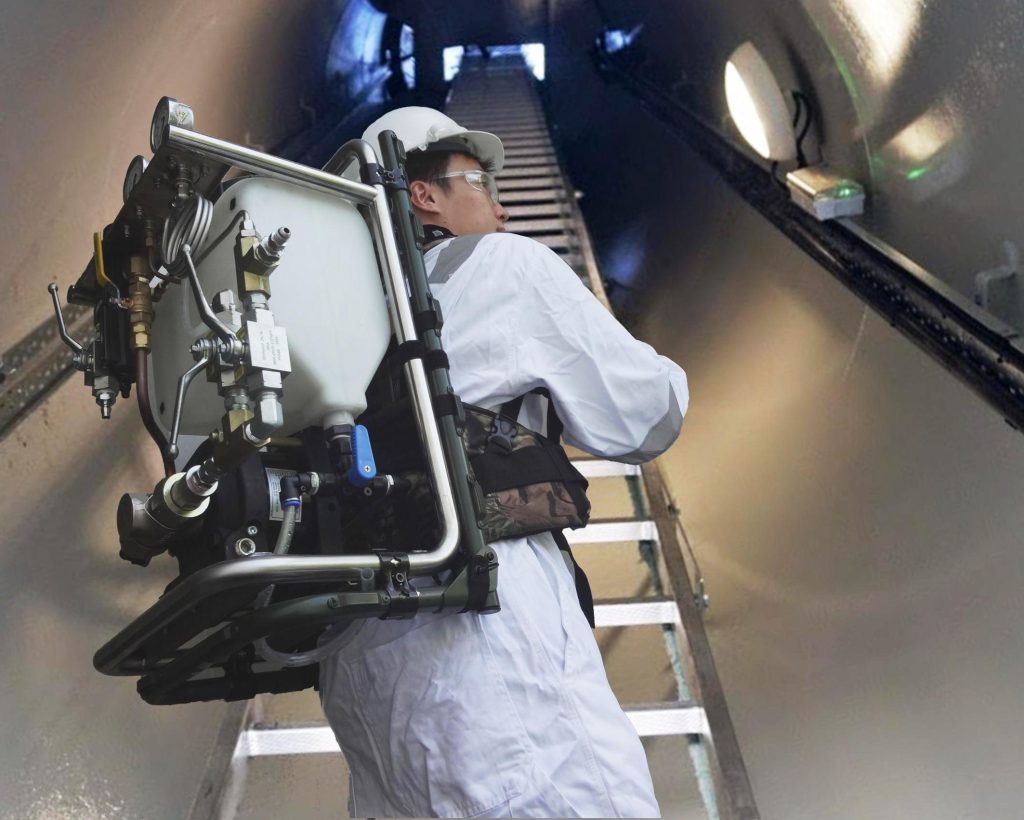 Worker using backpack-mounted hydraulic test unit