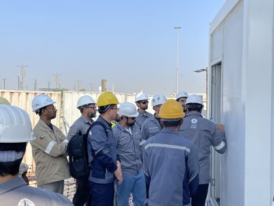 Engineers and workers in PPE on a site visit team