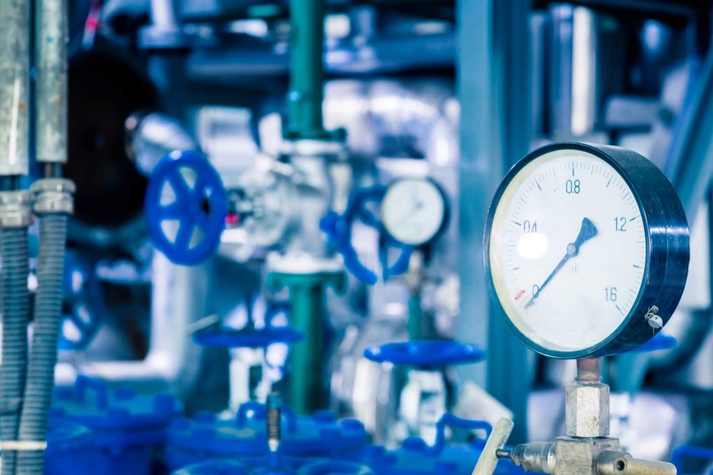 Industrial piping with pressure gauge installed.
